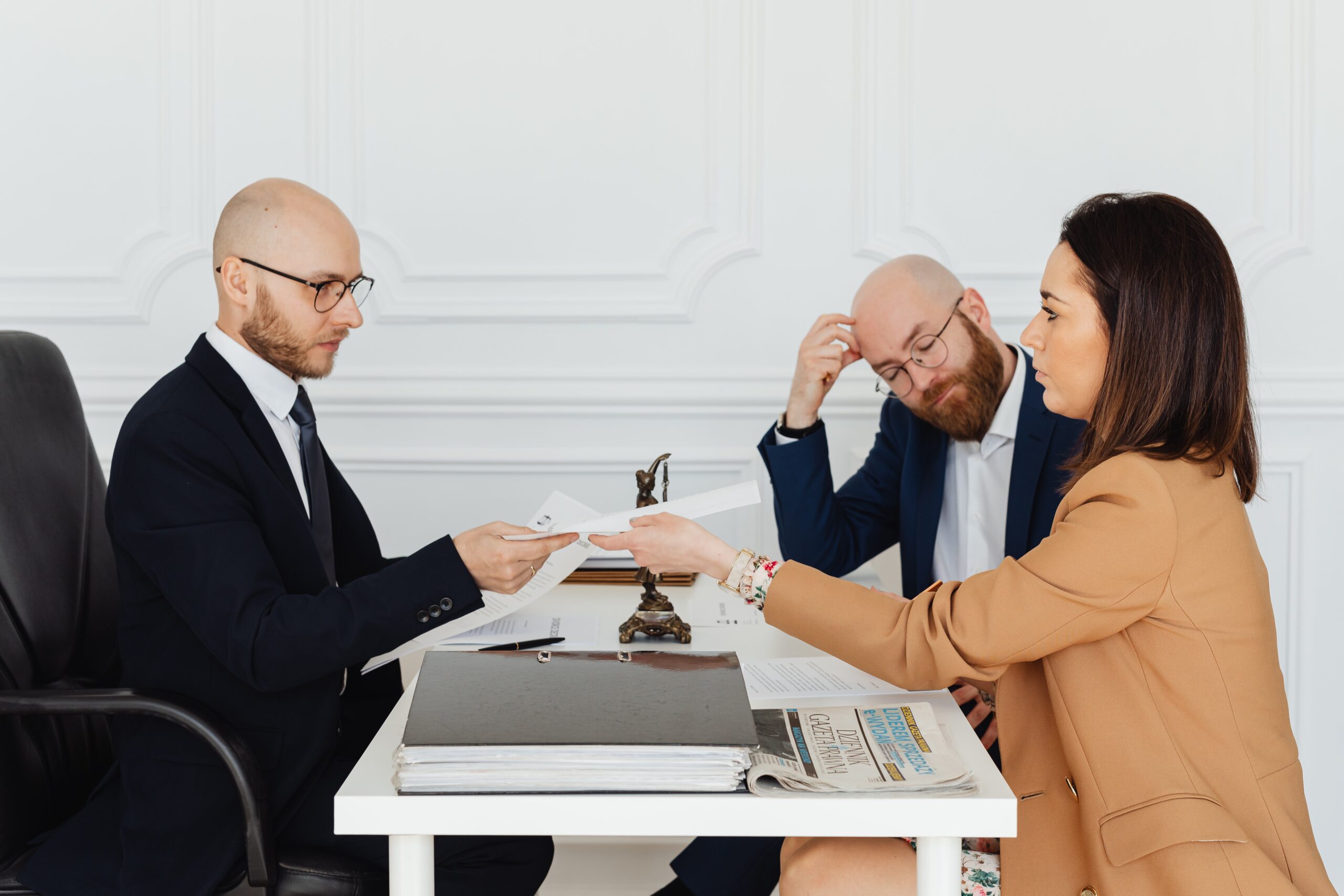 couple sitting at a table in front of a professional discussing documents