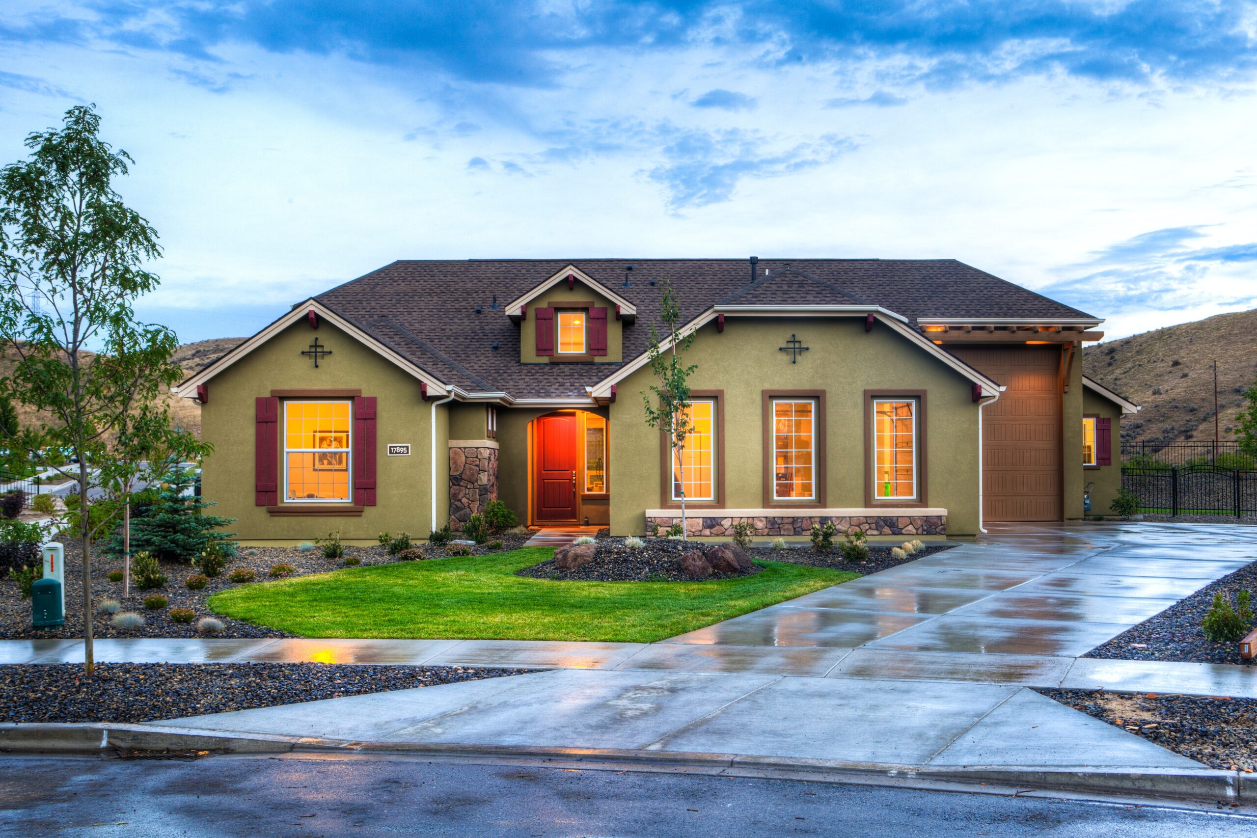 beige house with lights on inside