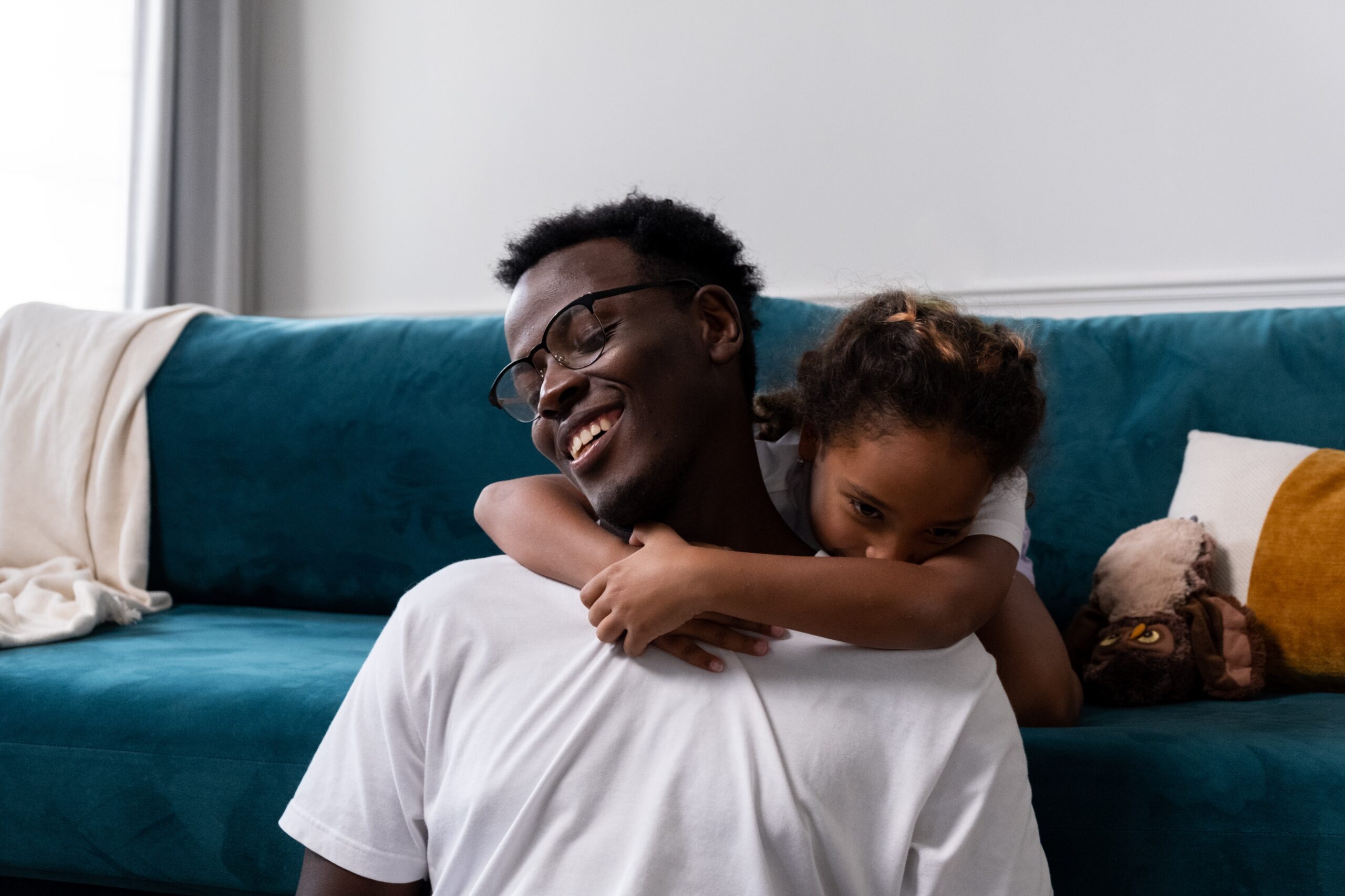 young girl hugging a smiling man