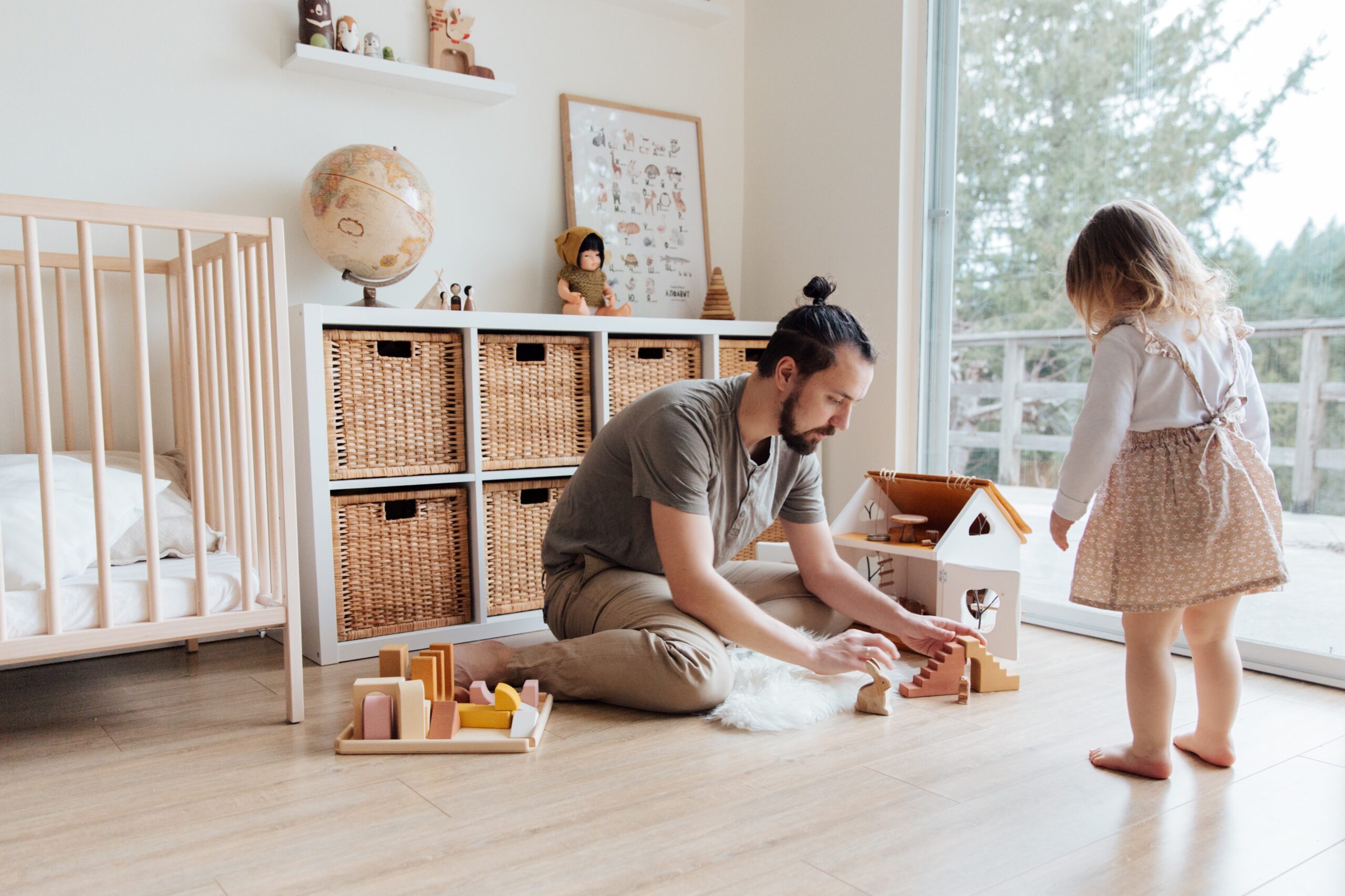 father playing with toys with daughter in her room