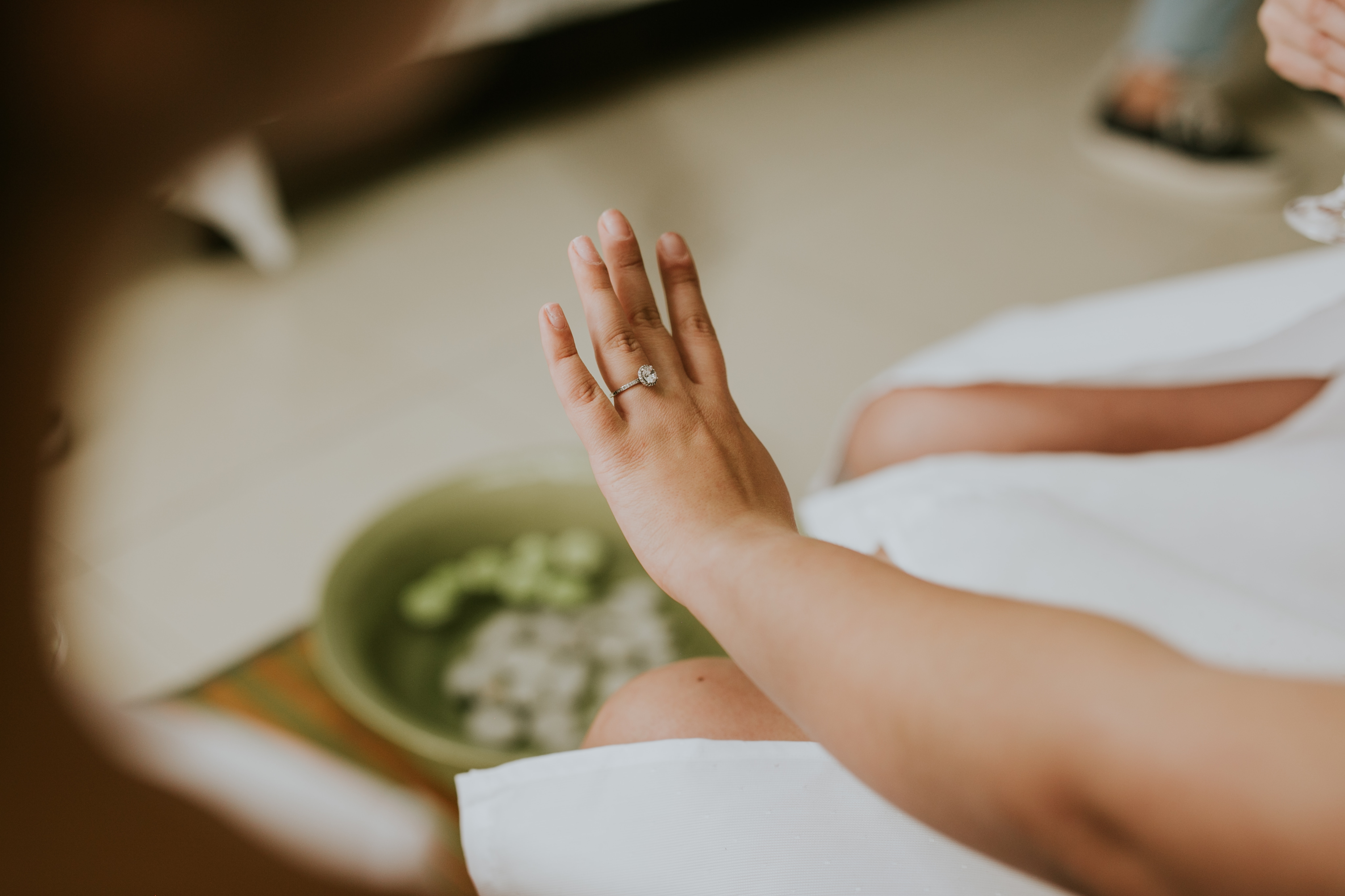 woman's hand wearing an engagement ring