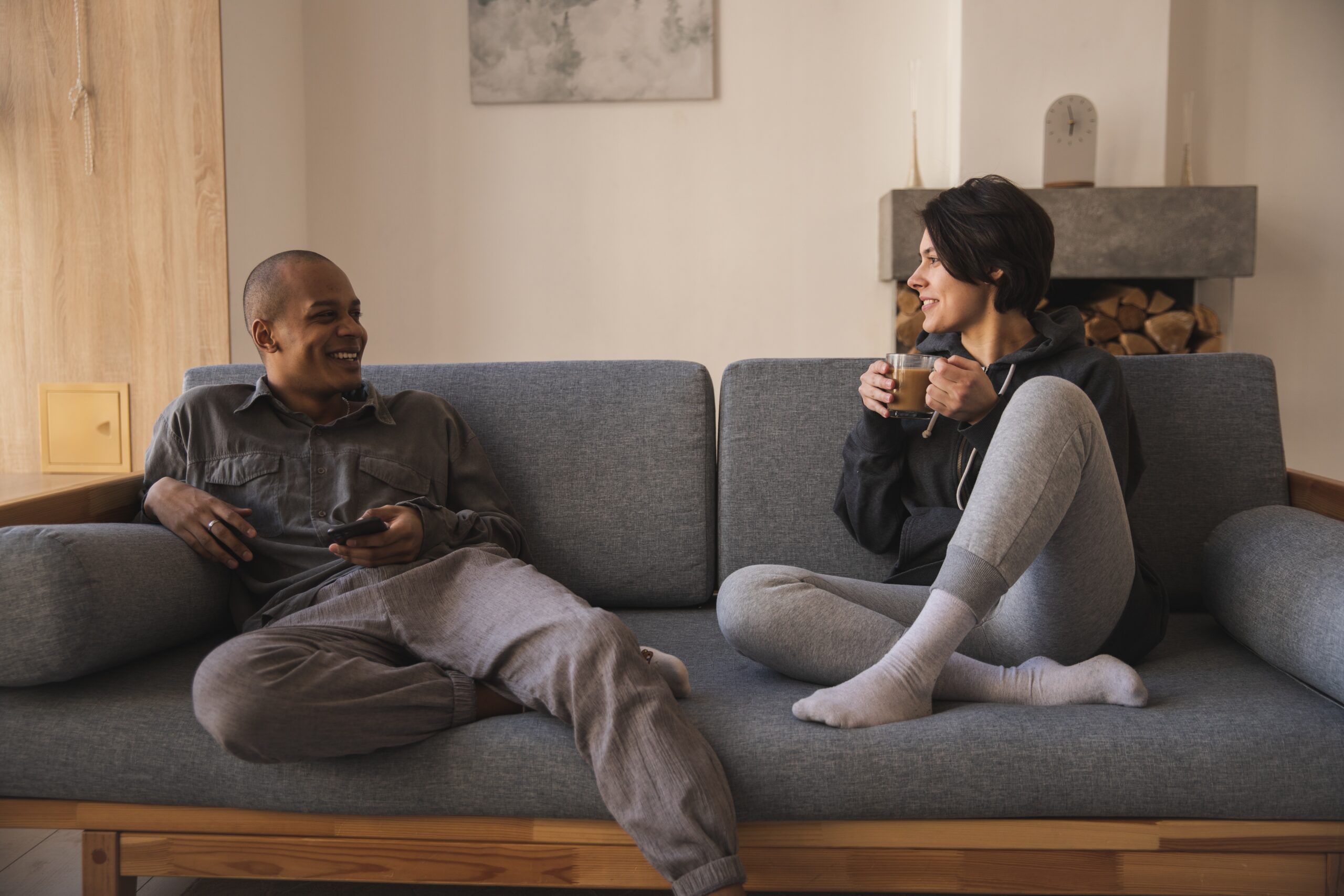 couple sitting casually on a couch talking