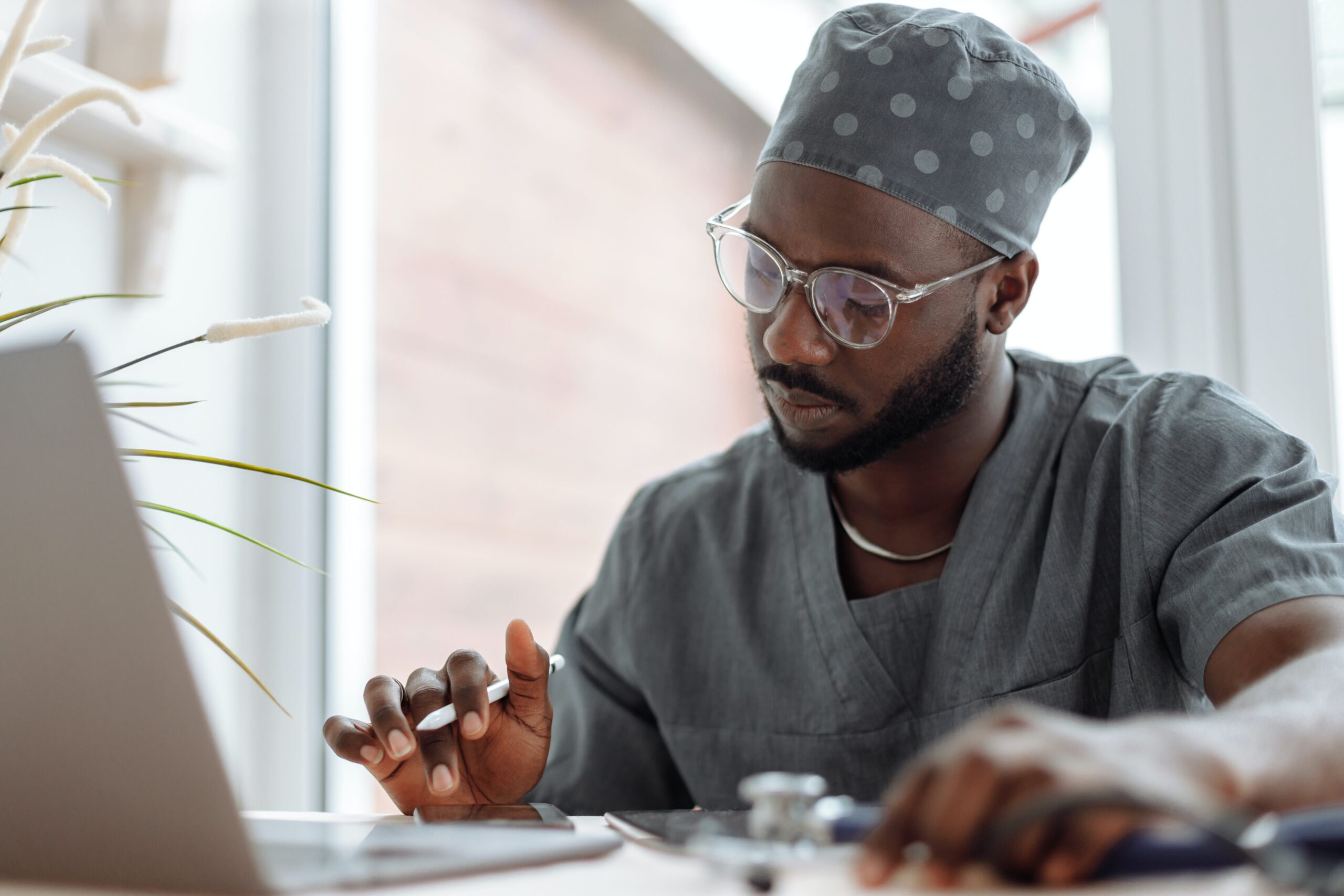 male doctor working at a laptop